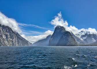 Iconic Milford Sound mountain scenery beneath heavy clouds