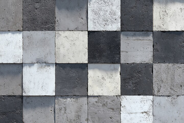 Geometric pattern of rough textured concrete squares in alternating light and dark grey shades