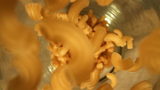 Super slow motion dry macaroni pasta . Filmed on a high-speed camera at 1000 fps. High quality FullHD footage