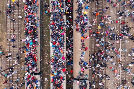 Tongi, Bangladesh - 12 January 2020: Aerial view of a sea of people, a vibrant tapestry of color, spills onto the railway tracks and platforms at Tongi Rail Station.