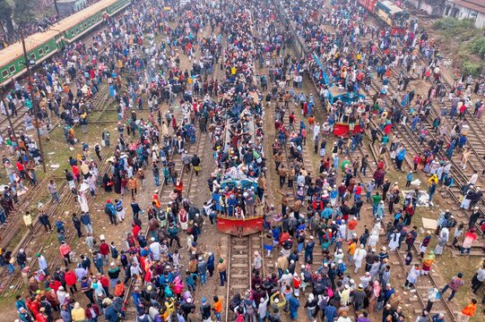 Tongi, Bangladesh - 12 January 2020: Aerial view of a sea of humanity floods the Tongi Rail Station, a vibrant tapestry of color against the stark steel of the tracks.