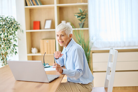 Portrait of a mature senior woman a businesswoman working from home having a meeting online, home office, or a student learning, or mature woman surfing net shopping or reading - Powered by Adobe