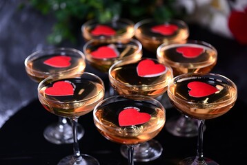Valentine&rsquo;s Day Love Concept with Champagne Glasses and Red Hearts on Black Background.