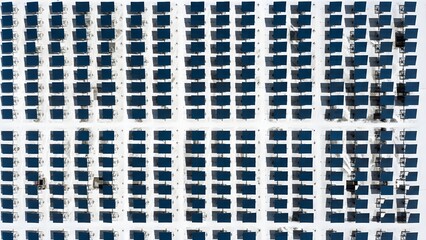Large solar panel farm with rows of blue photovoltaic cells