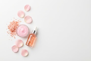 minimalist top-down view of pink salt, rose cream, and rose essential oil bottle on smooth white background. banner concept for sales or promotional materials for aesthetics,personal care products