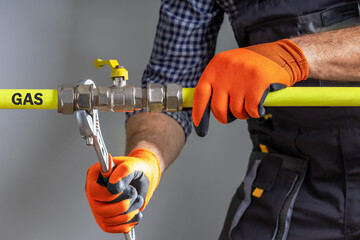  Technician repairing gas pipeline.  A specialist checks the gas pipeline.