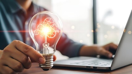 Creative Idea Concept with Light Bulb and Laptop Workspace