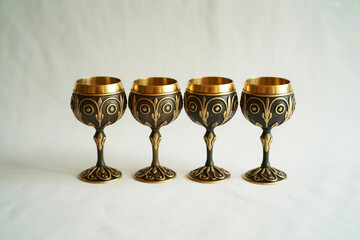 A product photo of four ornate medieval-style goblets arranged in a horizontal line against a white background.