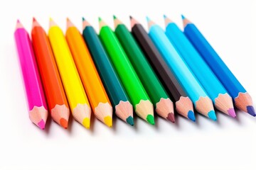 Fototapeta premium Sharp colored pencils creating a colorful line against a white background