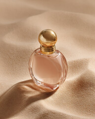 Elegant glass perfume bottle with golden cap on soft beige fabric, evoking luxury and warmth
