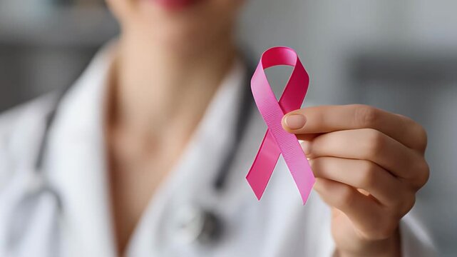 World Cancer Day woman doctor holding pink ribbon cancer awareness healthcare concept. February 4th
