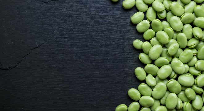 Shelled Fresh Green Fava Beans Pattern on Dark Textured Slate Background, Minimalist Composition for Healthy Eating and Nutrition Concepts