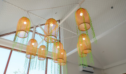 Rustic wicker lamps hanging gracefully from a high ceiling.