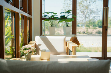 Natural light streaming through the windows, creating a peaceful cafe atmosphere.