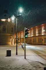 It is snowing in the city at night