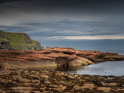 Rocky coast with green cliffs at Fraserburgh Scotland