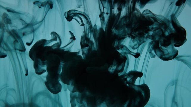Abstract Black Ink Swirling in Blue Water Creating Ethereal Smoke Patterns for Moody Artistic Background Wallpaper and Creative Graphic Design Projects