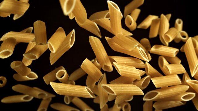 Super slow motion flying dry penne pasta . Filmed on a high-speed camera at 1000 fps. High quality FullHD footage