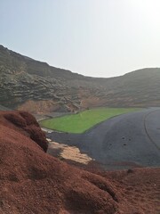 Lanzarote volcanic Lake and ocean beach in El Golfo, Canary Islands, Spain. Charco de los Clicos