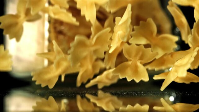 Super slow motion dry farfalle pasta . Filmed on a high-speed camera at 1000 fps. High quality FullHD footage