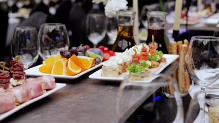 Elegant gourmet appetizers surrounding wine glasses, presenting refined culinary selection during upscale catered gathering with sophisticated presentation