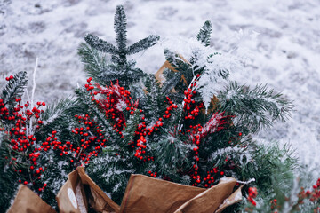 Christmas bouquet pine holly red berries kraft paper background.