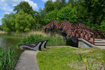 Wooden footbridge over a pond in a park