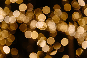 blurred yellow lights, in black background, abstract bokeh, garland lights