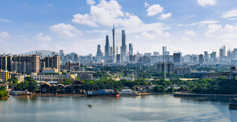 Fototapeta premium Scenic panoramic view of Guangzhou city skyline and river in China during a clear day.
