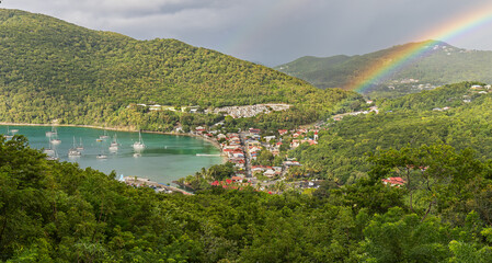 Small town Deshaies (Caribbean island Guadeloupe) at late afternoon with rainbow 