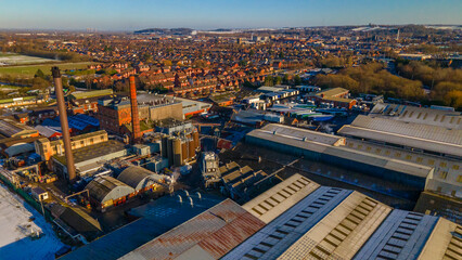 Obraz premium Aerial view of the industrial brewery district and residential houses in winter