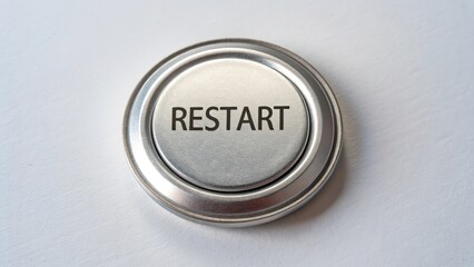 A round metal button labeled Restart centered in focus