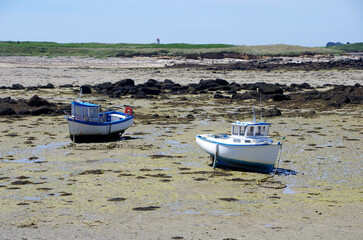 Small boats at low tide in Brittany in France, Europe