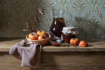 Still life with persimmon, persimmon compote and persimmon jam.
