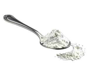 A stainless steel spoon holds a mound of white powder with a few grains spilled