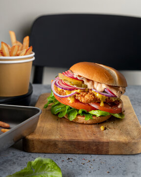Crispy Chicken Burger with Lettuce, Tomato and Sauce Served with French Fries
