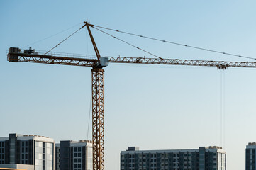 Tower crane over modern city construction site