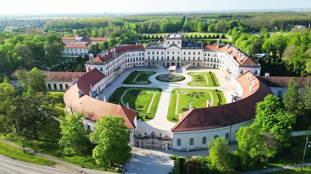 Aerial view of Esterhazy Castle, a beautiful white building with red roof, surrounded by lush green trees, Fertod, Sopron, Hungary.