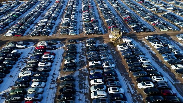 Aerial view of neatly organized rows of new cars at the BCA car storage facility, creating a vast, geometric landscape of vehicles, Corby, United Kingdom.