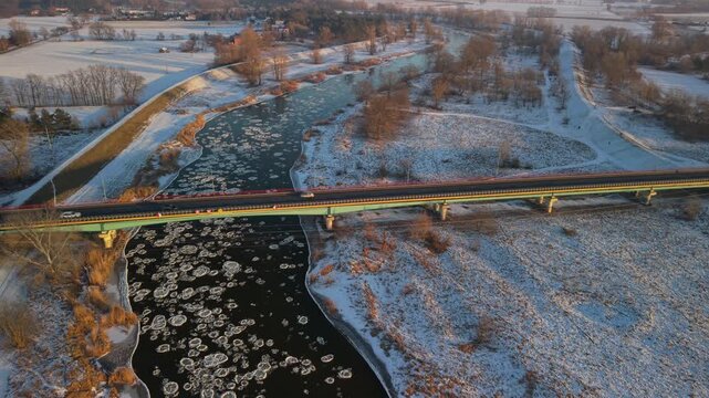 aerial view of Winter Warta River with Ice Floes and Bridge