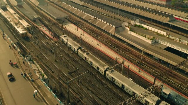 Aerial view of trains waiting at Howrah Railway Station, tracks, and platforms create a geometric tableau of steel and concrete, Howrah, West Bengal, India.