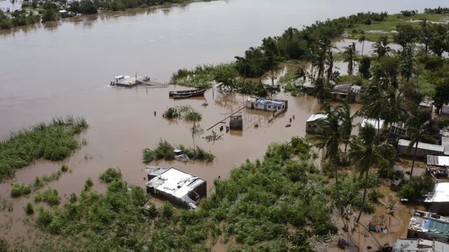 Aerial view of flooded buildings and trees emerging from the murky floodwaters, showcasing the devastation, Beira, Sofala Province, Mozambique.