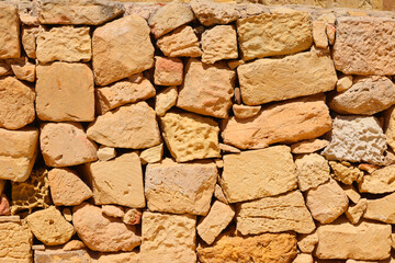 Fototapeta premium Handmade stone wall of ancient house in Victoria Gozo Island Malta