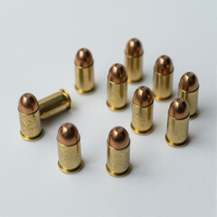 Group of brass-cased pistol rounds with copper rounded tips scattered on a white background