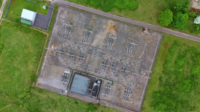 Aerial view of Wymondley electrical sub station surrounded by green fields, an industrial landscape contrasting with nature, Wymondley, Hitchen, United Kingdom.