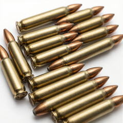 Group of shiny brass rifle cartridges with copper tips laid on a white background