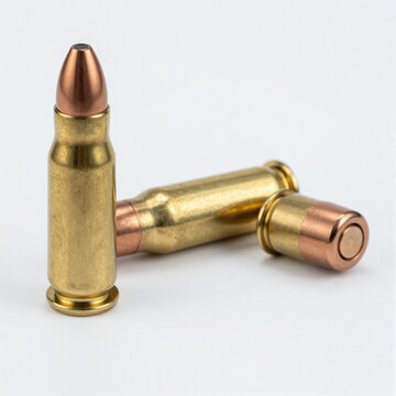 Close-up of polished brass large-caliber bullets with copper tips on a white background