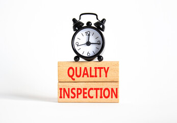 Quality Inspection symbol. Concept word Quality Inspection on wooden blocks. Beautiful white background with alarm clock. Business and Quality Inspection concept. Copy space