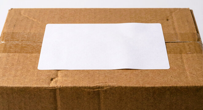 Cardboard Shipping Box with Blank White Label on Top
