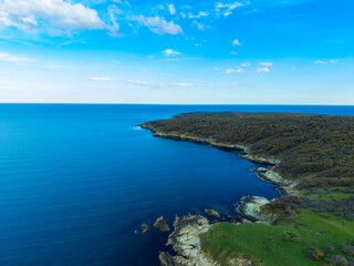 Obraz premium View of coastline with water and rocks under a clear sky during daytime in a natural setting near the shore